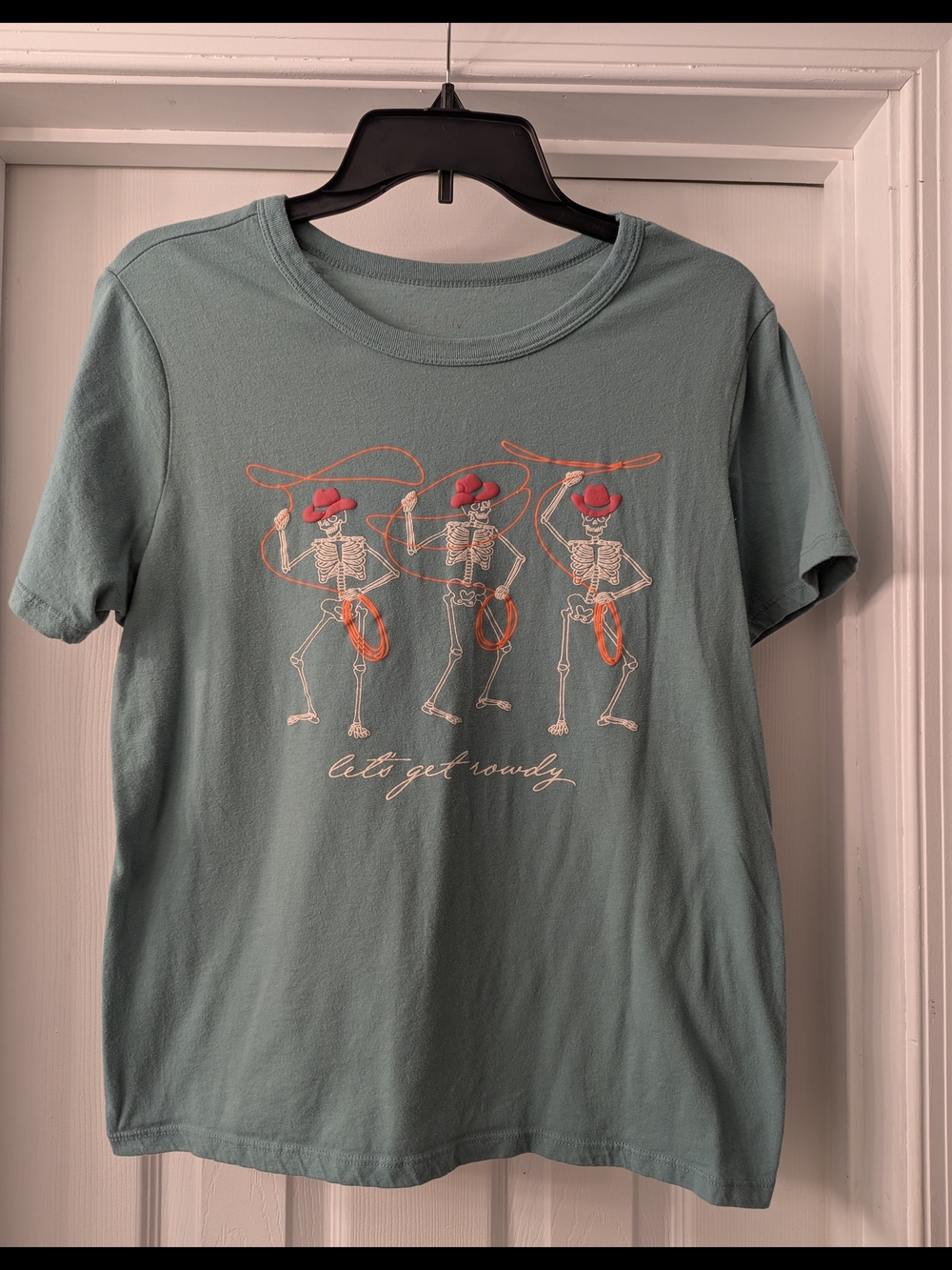 Teal Graphic Tee with Dancing Skeletons and Pink Cowboy Hats